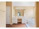 Main bathroom features double vanity, soaking tub, private toilet and modern fixtures at 523 Huntgate Rd, Woodstock, GA 30189
