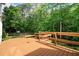 Beautiful wooden deck with seating area surrounded by lush trees, perfect for outdoor enjoyment at 523 Huntgate Rd, Woodstock, GA 30189