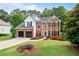 Charming brick two-story home with a two-car garage and a beautifully landscaped front yard at 523 Huntgate Rd, Woodstock, GA 30189