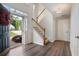 Bright foyer featuring hardwood floors, a staircase, and natural light from the front door at 523 Huntgate Rd, Woodstock, GA 30189