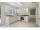 Clean kitchen features stainless appliances, white cabinets, and tiled floor at 523 Huntgate Rd, Woodstock, GA 30189