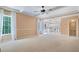 Spacious living room with open floor plan boasts fireplace, fan, crown molding and lots of light at 523 Huntgate Rd, Woodstock, GA 30189