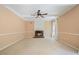 Open-concept living room boasts fireplace, fan, crown molding, neutral tones and lots of light at 523 Huntgate Rd, Woodstock, GA 30189