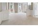 Spacious living room with white carpet, windows letting in natural light, and classic column details at 523 Huntgate Rd, Woodstock, GA 30189