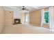 Cozy living room with a fireplace, neutral carpeting, and natural light at 523 Huntgate Rd, Woodstock, GA 30189