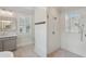 Bathroom featuring a glass enclosed shower and vanity with modern fixtures and shuttered windows at 5981 Brundage Ln, Norcross, GA 30071