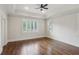 Spacious bedroom with hardwood floors, tray ceiling, and natural light at 5981 Brundage Ln, Norcross, GA 30071