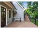 Spacious wooden deck featuring black railings, ideal for outdoor relaxation and entertaining with access to stairs and the house at 5981 Brundage Ln, Norcross, GA 30071