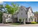 Charming gray home with lush landscaping, showcasing its inviting curb appeal and classic architectural details at 5981 Brundage Ln, Norcross, GA 30071