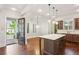 Bright kitchen features a large island with pendant lighting, stainless appliances, and hardwood flooring at 5981 Brundage Ln, Norcross, GA 30071