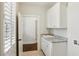 Laundry room featuring tile floors, granite countertops and white cabinets at 5981 Brundage Ln, Norcross, GA 30071