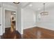 Elegant open-concept layout featuring hardwood floors, white trim, plantation shutters, and an ornate chandelier at 5981 Brundage Ln, Norcross, GA 30071