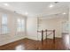 An upstairs living area with hardwood floors, white trim, and staircase at 5981 Brundage Ln, Norcross, GA 30071