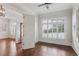 Open-concept living space featuring hardwood floors, white trim, plantation shutters, and a modern ceiling fan at 5981 Brundage Ln, Norcross, GA 30071