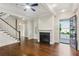 Open living room with hardwood floors, fireplace, and access to the front porch at 5981 Brundage Ln, Norcross, GA 30071