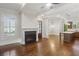 Elegant open-concept design showcasing hardwood floors, a fireplace, modern lighting, and a stylish kitchen island at 5981 Brundage Ln, Norcross, GA 30071