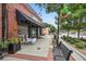 Inviting storefront with a black awning, outdoor seating, and benches for a relaxed, pedestrian-friendly atmosphere at 5981 Brundage Ln, Norcross, GA 30071