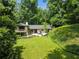 Aerial view of a home with a large backyard, patio, and lush greenery at 1053 Crane Ne Rd, Atlanta, GA 30324