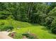 Landscaped backyard with mature trees and lush greenery create a private and serene setting at 1053 Crane Ne Rd, Atlanta, GA 30324