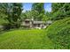 Green backyard with a home featuring a balcony and patio area at 1053 Crane Ne Rd, Atlanta, GA 30324