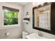 Cozy bathroom featuring a stylish mirror, window with a view, and elegant towel arrangement at 1053 Crane Ne Rd, Atlanta, GA 30324