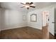 Bright bedroom featuring hardwood floors, ceiling fan, and ample natural light from the large windows at 1053 Crane Ne Rd, Atlanta, GA 30324