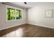 Sunlit bedroom showcasing hardwood floors, a ceiling fan, and large windows, perfect for relaxation and comfort at 1053 Crane Ne Rd, Atlanta, GA 30324