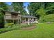 Beautiful two-story home with a balcony and patio surrounded by lush greenery at 1053 Crane Ne Rd, Atlanta, GA 30324