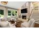 Cozy living room with fireplace and views of outdoor patio, perfect for relaxation at 1053 Crane Ne Rd, Atlanta, GA 30324