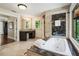 Large bathroom with spa tub, dual sink vanity, marble tile and picture window at 1053 Crane Ne Rd, Atlanta, GA 30324