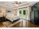 Serene main bedroom featuring tray ceilings, lots of natural light, and a private balcony at 1053 Crane Ne Rd, Atlanta, GA 30324