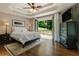 Bright main bedroom features a trey ceiling, ceiling fan, hardwood floors, and access to private deck at 1053 Crane Ne Rd, Atlanta, GA 30324