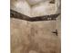 Walk-in shower features designer tile, a shower bench, and a mounted shower head at 1053 Crane Ne Rd, Atlanta, GA 30324
