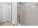 Bathroom with a shower and tub, featuring white tile and diamond pattern accents at 1850 Cotillion Dr # 3215, Atlanta, GA 30338