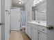 Bathroom features white cabinets, a large mirror, and a door to the shower at 1850 Cotillion Dr # 3215, Atlanta, GA 30338