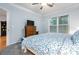 Bright bedroom features a TV on a dresser, neutral paint, carpet, and a window with blinds for natural light at 1850 Cotillion Dr # 3215, Atlanta, GA 30338