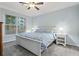 Bright bedroom features a ceiling fan, neutral paint, carpet, and a window with blinds for natural light at 1850 Cotillion Dr # 3215, Atlanta, GA 30338