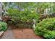 Picturesque courtyard featuring lush greenery, a wooden pergola, brick walkway and outdoor art at 1850 Cotillion Dr # 3215, Atlanta, GA 30338