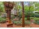 Picturesque courtyard featuring lush greenery, a wooden pergola, and charming fountain, offering a serene retreat at 1850 Cotillion Dr # 3215, Atlanta, GA 30338