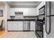 Updated kitchen features white cabinets, stainless steel appliances, and black countertops at 1850 Cotillion Dr # 3215, Atlanta, GA 30338