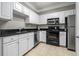 Modern kitchen with white cabinetry, stainless steel appliances, and granite countertops at 1850 Cotillion Dr # 3215, Atlanta, GA 30338