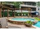 Outdoor hot tub with a stone surround and seating area with lush greenery at 1850 Cotillion Dr # 3215, Atlanta, GA 30338