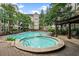 Outdoor pool and hot tub surrounded by lounge chairs and lush landscaping at 1850 Cotillion Dr # 3215, Atlanta, GA 30338