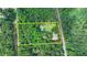 Aerial view of the wooded property featuring a home, pool, and yellow outline at 2864 Winder Hwy, Dacula, GA 30019