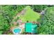 An aerial view of a property with a home, pool, garden, and plenty of lawn and trees at 2864 Winder Hwy, Dacula, GA 30019