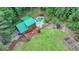 Close aerial view of a house with a green roof, pool, and back deck at 2864 Winder Hwy, Dacula, GA 30019