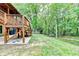 Expansive backyard featuring a wooden deck, lush greenery, and serene natural surroundings at 2864 Winder Hwy, Dacula, GA 30019