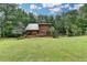 Lush backyard featuring a spacious deck, seating area, and a charming wooden fence at 2864 Winder Hwy, Dacula, GA 30019
