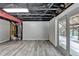Partially finished basement with new flooring and exposed ceiling, offering versatility for customization and additional living space at 2864 Winder Hwy, Dacula, GA 30019