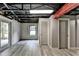 Spacious basement area with modern gray floors, neutral walls, and ample lighting, providing a blank canvas for customization at 2864 Winder Hwy, Dacula, GA 30019